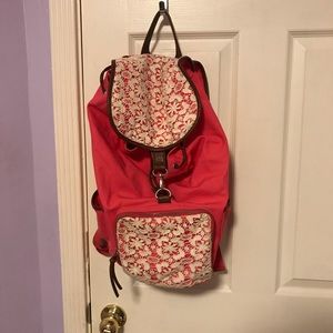 pink backpack with white floral designs